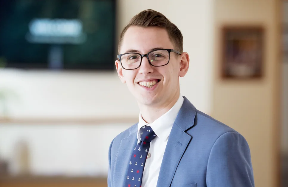 Co-founder of Uplist in a suit, smiling